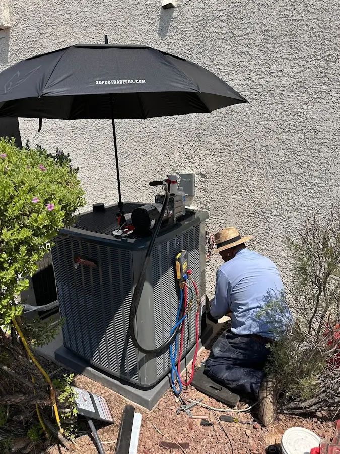 HVAC technician performing outdoor AC maintenance in South Orange Village