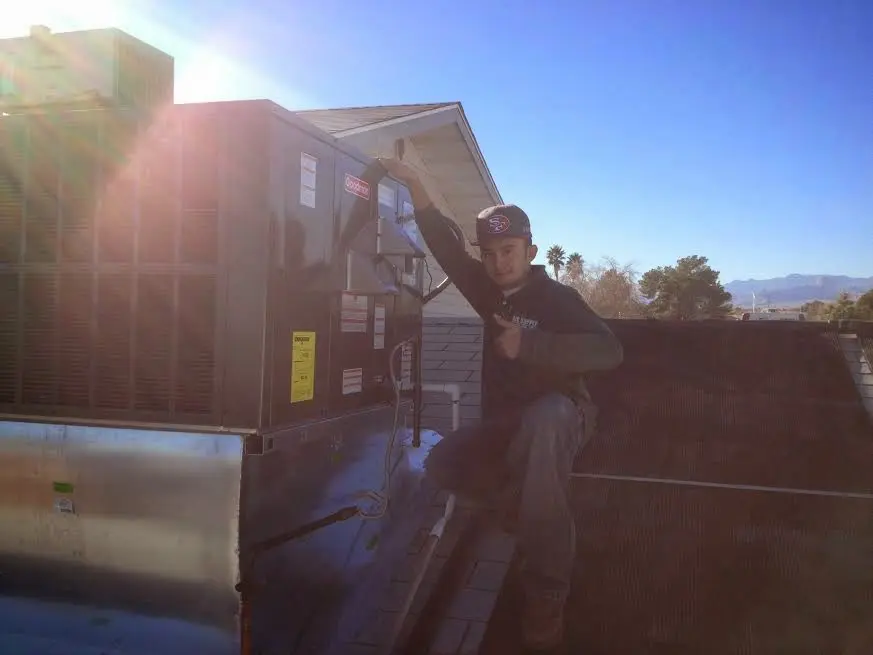 HVAC technician performing AC Tune-Up on a rooftop unit in South Orange Village